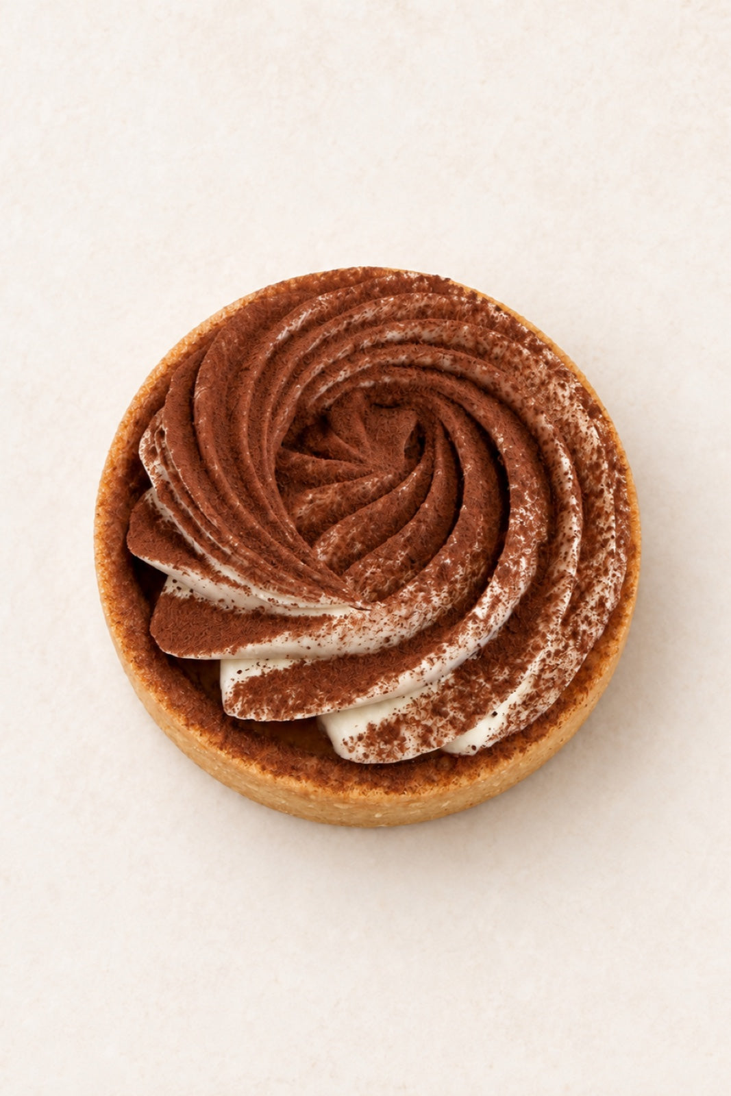 Coffee - Tonka Tartlet by Batida - almond shortcrust tart with cappuccino cream and cocoa, top view