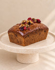 Pumpkin bread with cranberries and caramelised pumpkin seeds on a cake stand