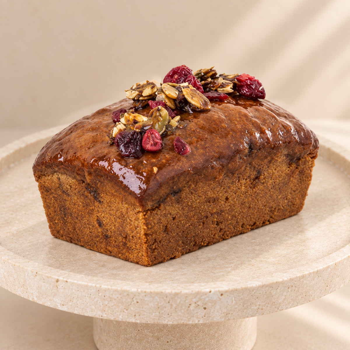 Pumpkin bread with cranberries, close-up of the shiny top and cranberries