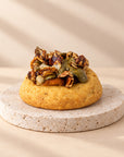 Pumpkin crumble cookie topped with praline pumpkin seeds and nuts