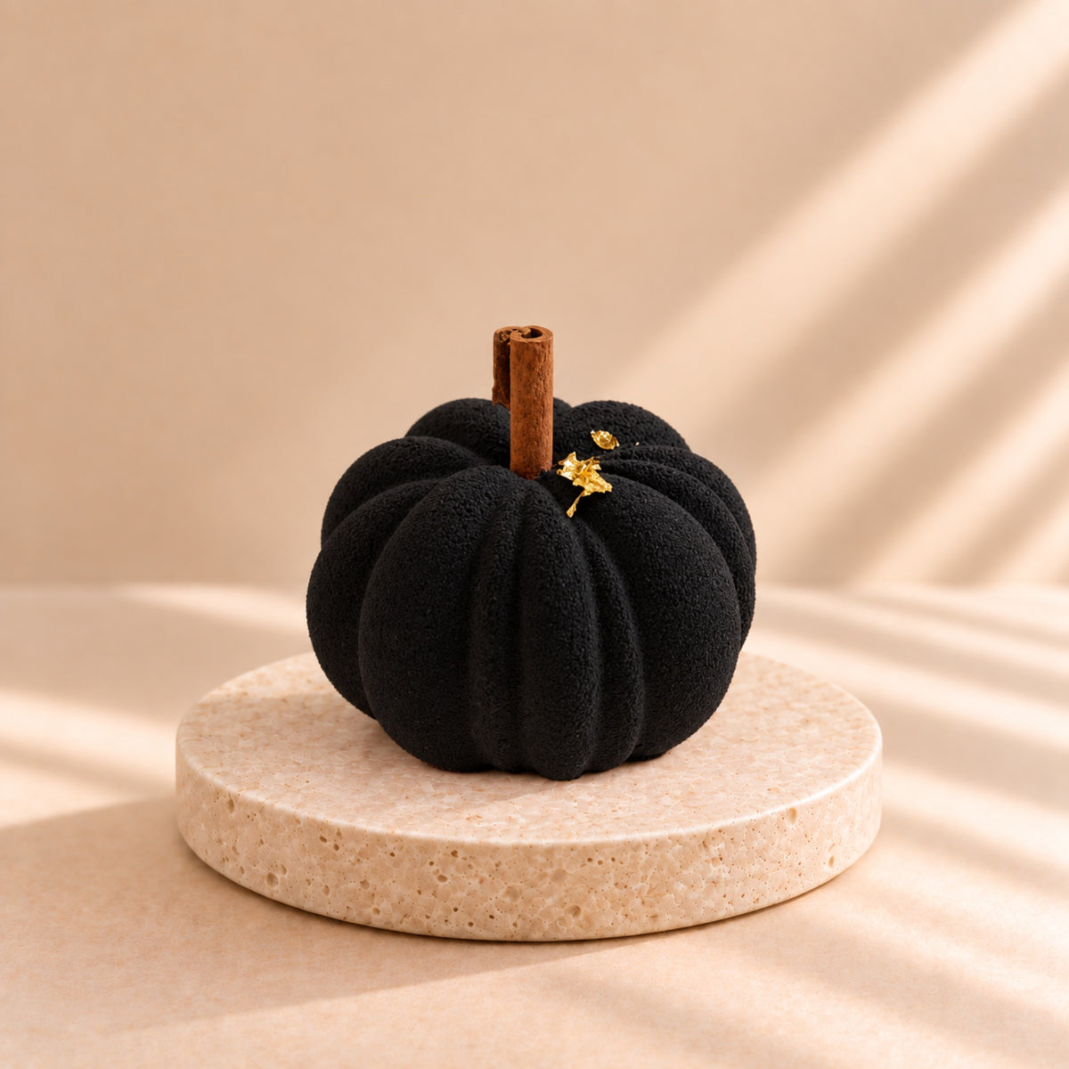 Pumpkin Latte Black - black pumpkin-shaped individual dessert with a cinnamon stick